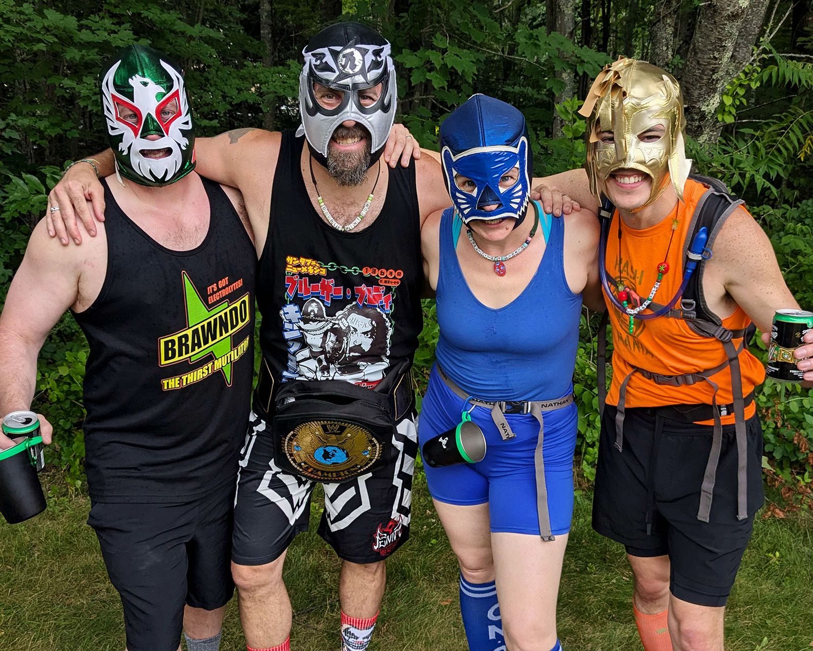 Four hashers in lucha libre wrestling masks posing arm in arm