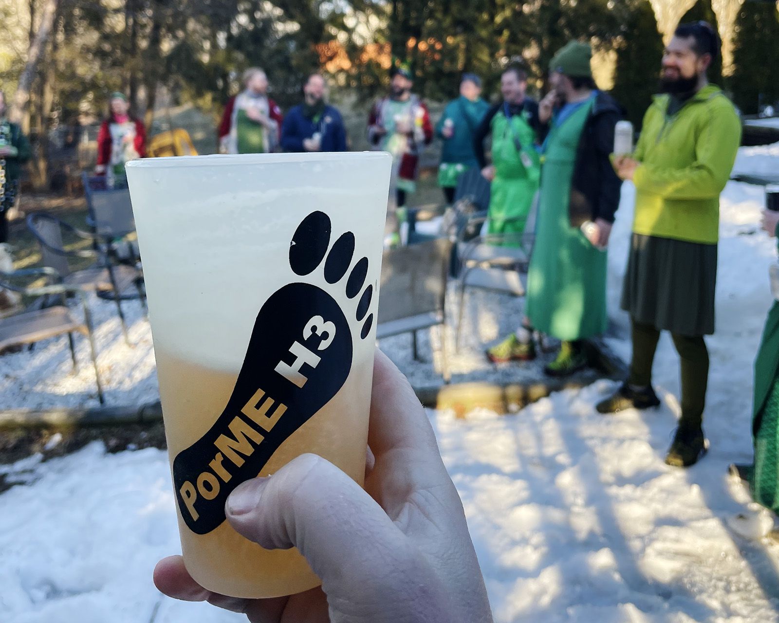A PorME H3 cup raised at a snowy circle